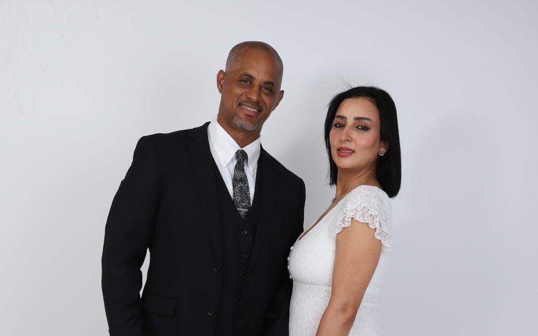 The two founders of Infinite King Agents, O. Abdullah Roberts and Nezha Roberts, standing together.
